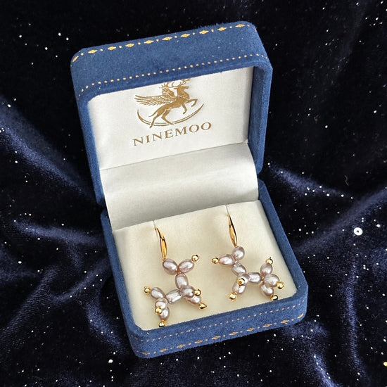 Purple Balloon Dog pearl earrings in a NINEMOO jewellery box