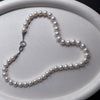 Étreinte de Perle Pearl Necklace arranged on a satin jewellery tray