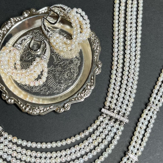 The Interlace Pearl Necklace styled with matching pearl earrings