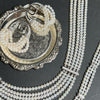 The Interlace Pearl Necklace styled with matching pearl earrings