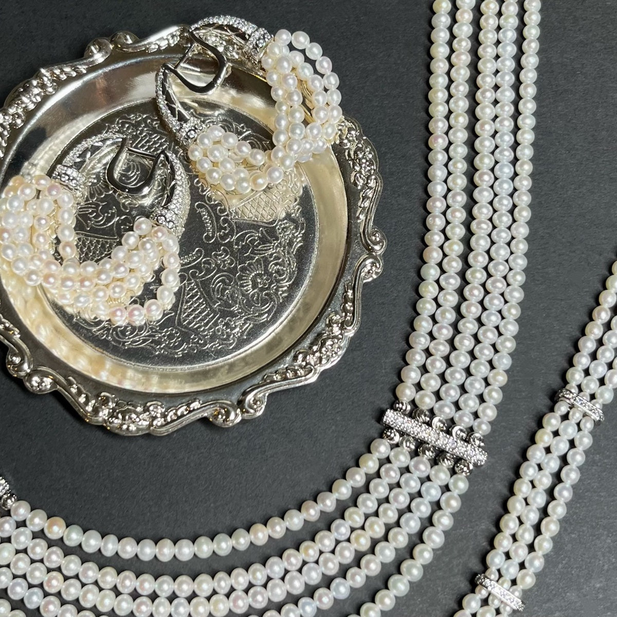 The Interlace Pearl Necklace styled with matching pearl earrings