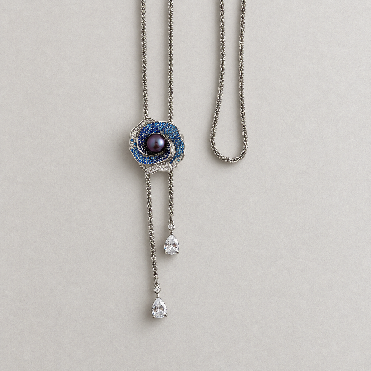 Midnight Orbit purple pearl brooch styled with a long chain