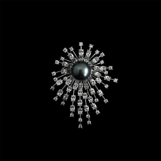 Nacre Noire starburst brooch black background