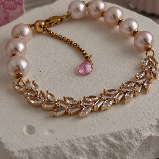 Close-up of pink freshwater pearls, clear stones and gold-filled details