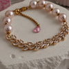 Close-up of pink freshwater pearls, clear stones and gold-filled details
