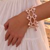 Ballet Rosé pink freshwater pearl weave bracelet worn on the wrist in warm evening light