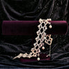 Ballet Rosé woven pink pearl bracelet displayed with its matching necklace on a purple velvet stand