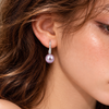 Model wearing Éclat de Lune natural purple pearl and sterling silver cubic zirconia hook earring