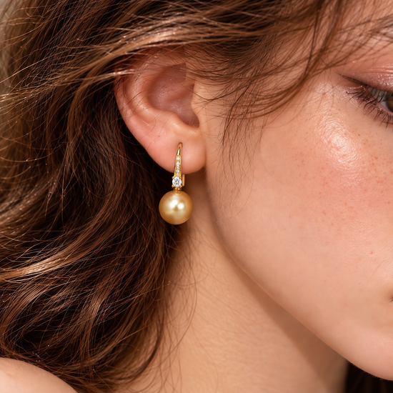 Model wearing Éclat de Lune natural golden pearl and gold-plated sterling silver cubic zirconia hook earring