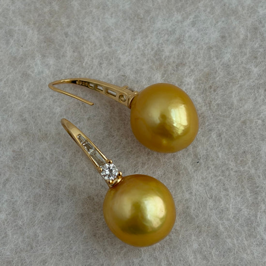 Close-up of natural golden pearl and gold-plated silver hook with cubic zirconia