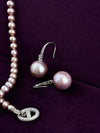 Natural purple pearl sterling silver drop earrings on violet velvet, showing pearl shape and lustre