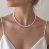Épure Petite Pearl Necklace by NINEMOO worn with a white camisole