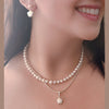 Model wearing NINEMOO star pearl earrings and a matching pearl pendant necklace