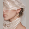 Lueur Rosée Gradient Crystal Hoop Earrings in gold tone worn on model