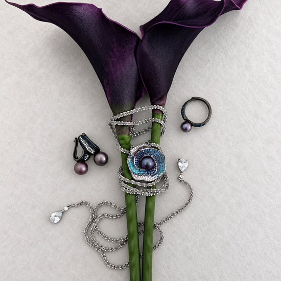 Midnight Orbit pearl jewellery styled with purple calla lilies