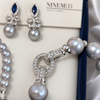 Close-up of the detachable stone-set circular clasp on the Nacre Gris freshwater pearl necklace