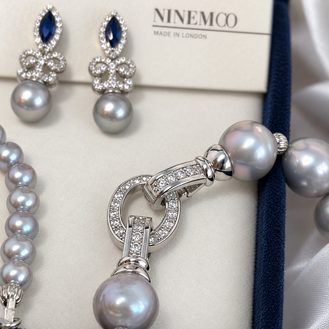 Close-up of the detachable stone-set circular clasp on the Nacre Gris freshwater pearl necklace