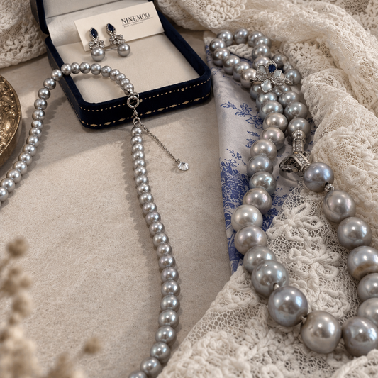 Nacre Gris grey freshwater pearl necklace styled with matching pearl jewellery on lace