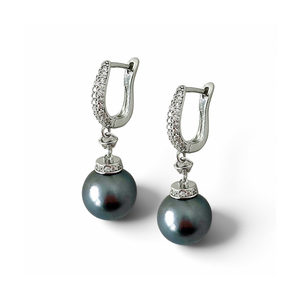 Nacre Noire pearl drop hoops white background
