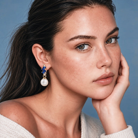 Model wearing NINEMOO Prisme Blue Pearl Drop Earrings with blue Cubic Zirconia and white Freshwater Pearls.