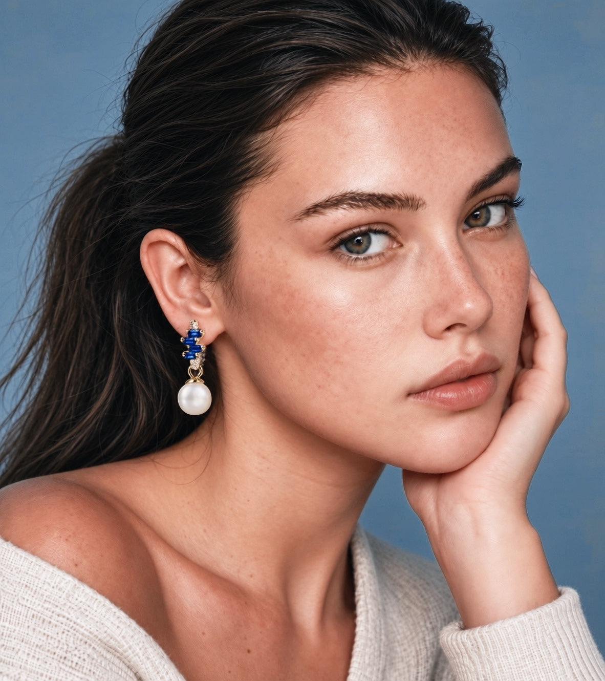 Model wearing NINEMOO Prisme Blue Pearl Drop Earrings with blue Cubic Zirconia and white Freshwater Pearls.