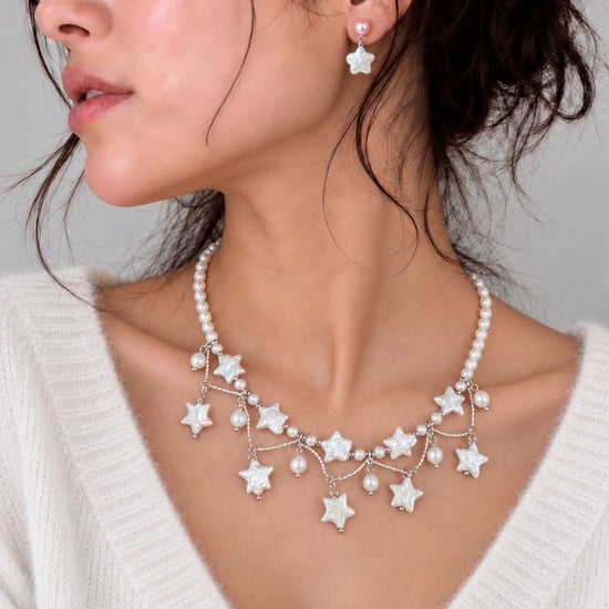 White Stardust Waltz freshwater pearl star fringe necklace on model in white cashmere; earrings sold separately