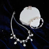 NINEMOO white star pearl necklace, pink pearl star earrings and iridescent pearl bracelet styled together; pieces sold separately