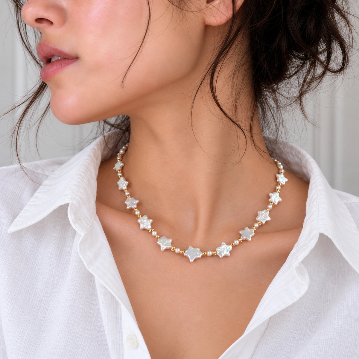 NINEMOO Starry Veil Pearl Necklace – natural white star-shaped Freshwater Baroque Pearls with gold-plated fittings, worn with a white shirt